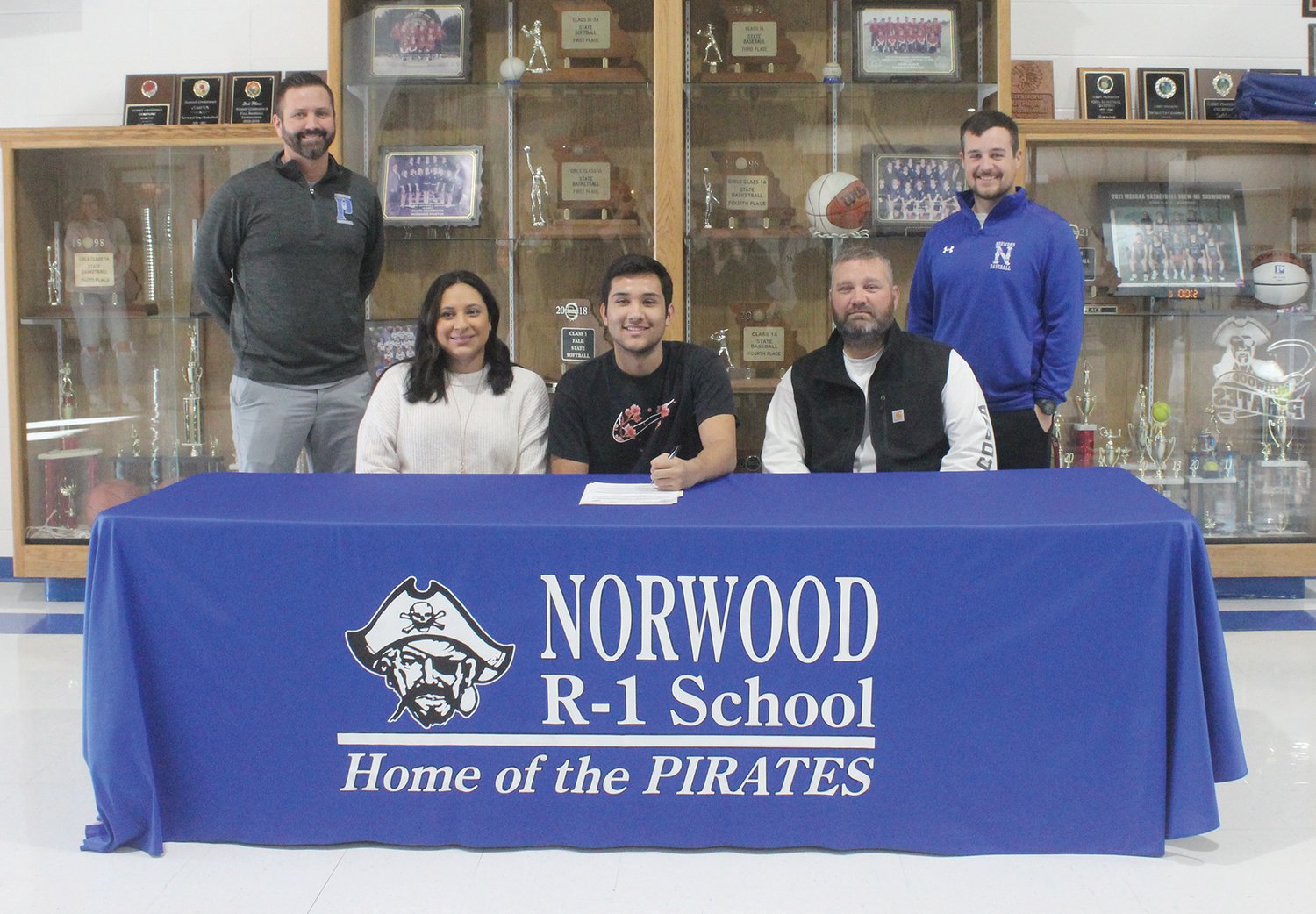 Norwood senior Jacob Sinning officially signed a letter of intent last week with North Arkansas College. Shown, seated, from left: Dinah Sinning (mom), Jacob Sinning and Brad Sinning (dad). Back row: Head basketball coach/athletic director Shane Chadwell, standing on left, and head baseball coach Drew Miller.